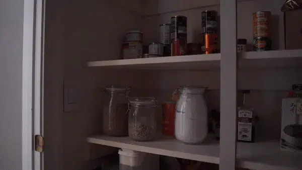 The Deako Simple Motion Sensor Switch turns on automatically in a pantry.